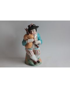 Tisanière porcelaine figurative Breton Joueur de biniou